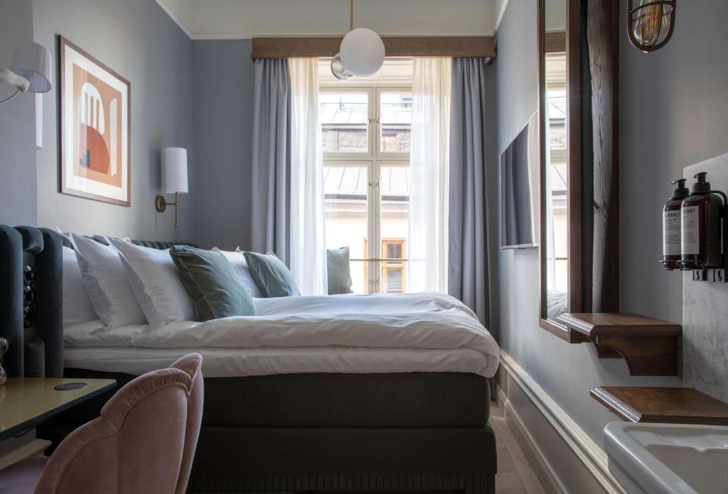 a bedroom with a large bed and a window at Hotel Frantz, WorldHotels Crafted in Stockholm