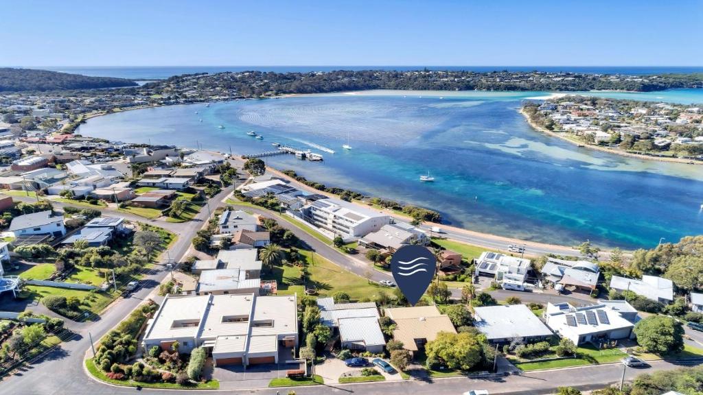 an aerial view of a beach with houses and the water at 8 Carolynne Street, Merimbula in Merimbula
