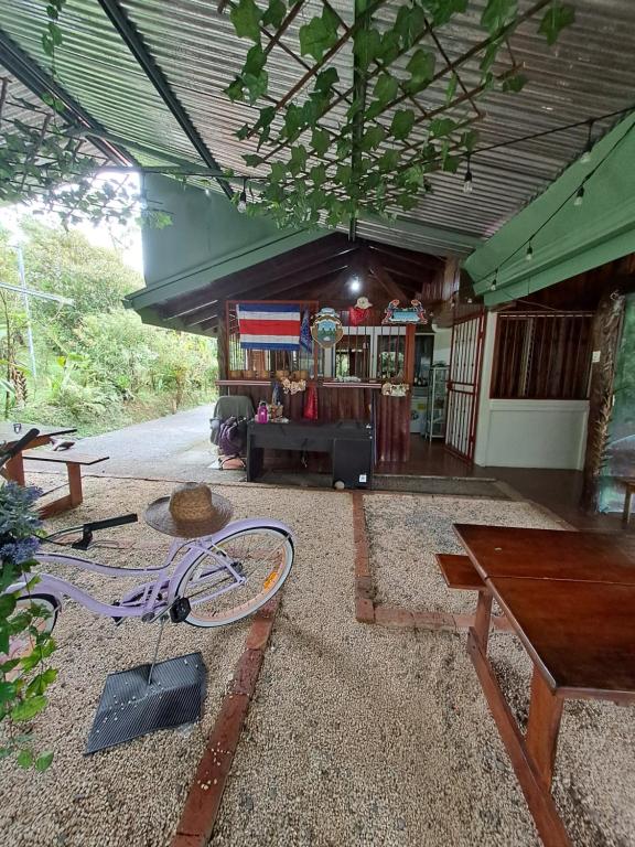 a building with a bike laying on the ground at Glamping Rio Celeste Heliconia in San Rafael