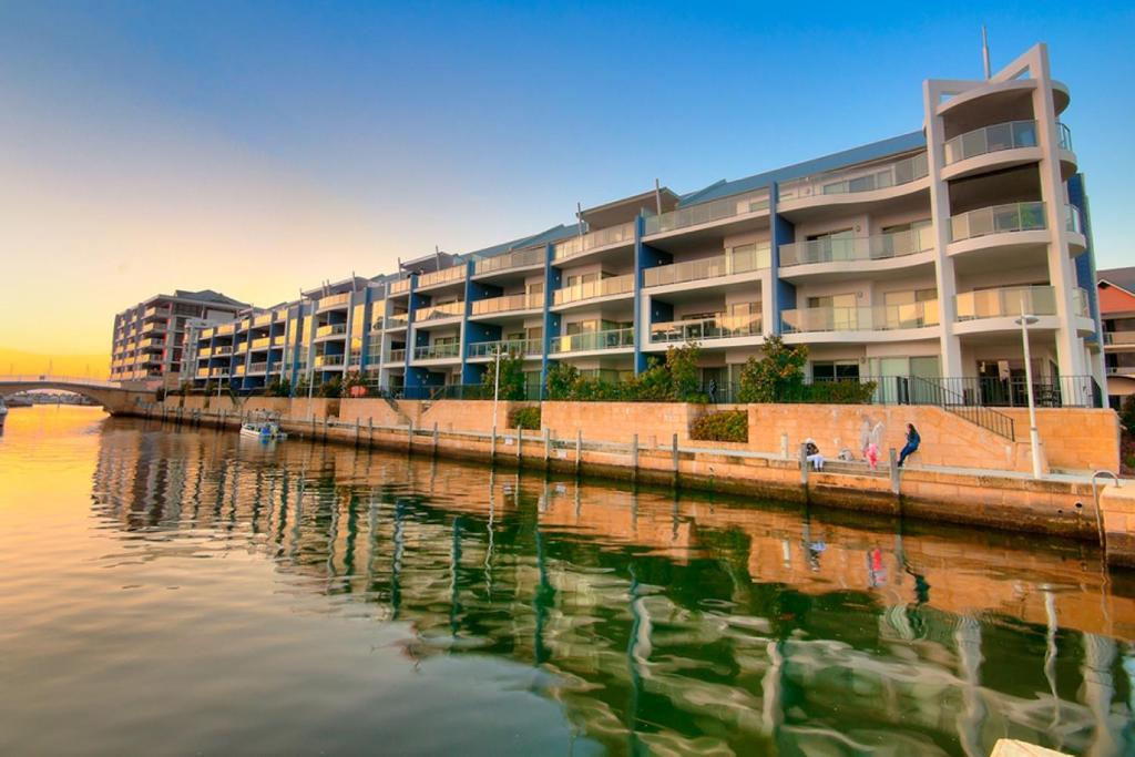 a large building next to a body of water at DelMar 3 in Mandurah