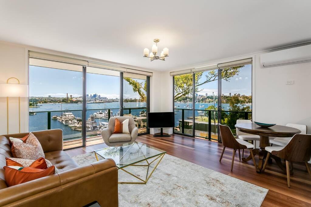 a living room with a view of the water at STG38 - stunning waterfront apartment - Drummoyne in Sydney