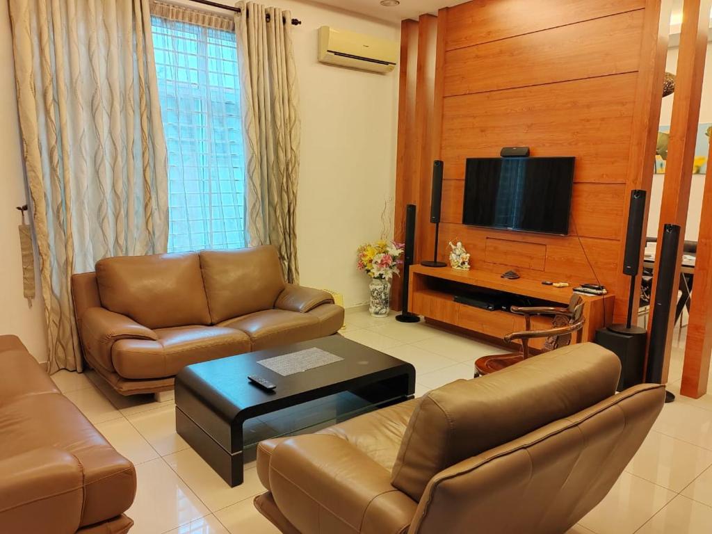 a living room with a couch and a tv at Nice semi D house at Tangkak in Tangkak