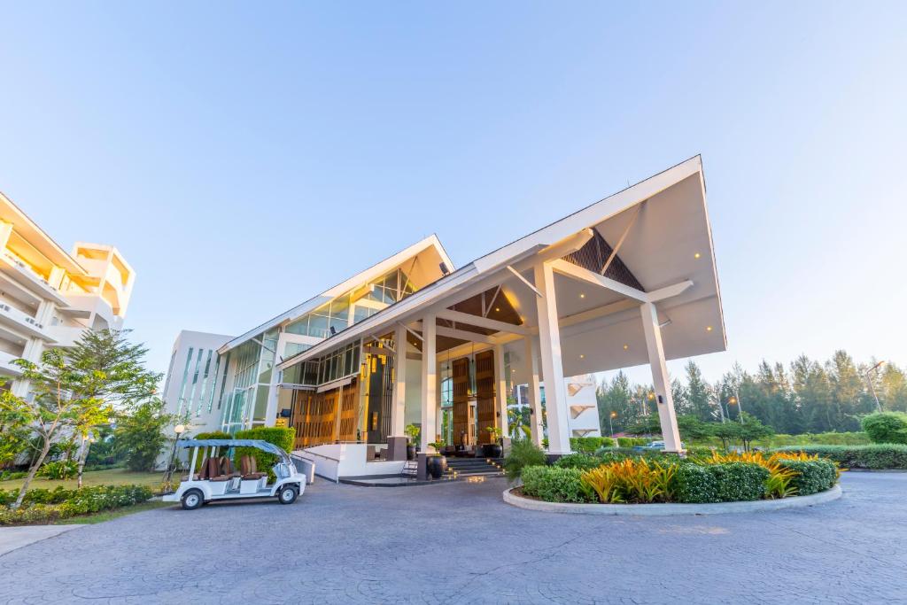 a golf cart parked in front of a building at Kantary Beach Hotel Villas & Suites in Khao Lak