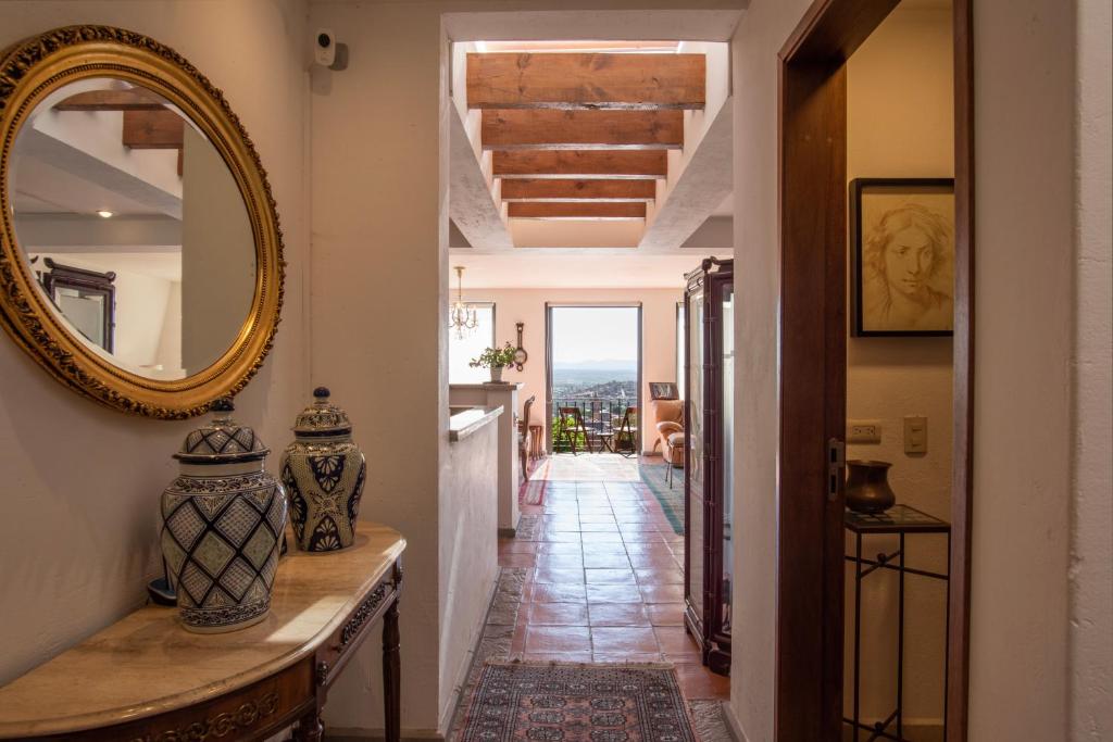 a hallway in a house with a mirror and a table at LA SUNSET CONDO in San Miguel de Allende