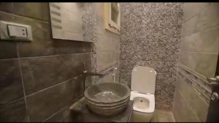 a small bathroom with a toilet and a sink at المهندسين خلف الاسواق الحره in Cairo