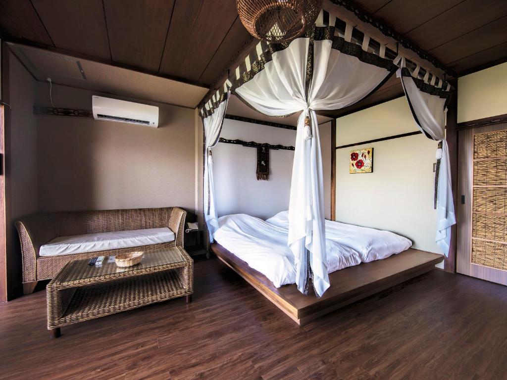 Postel nebo postele na pokoji v ubytování Bali Resort SAYA no Kaze