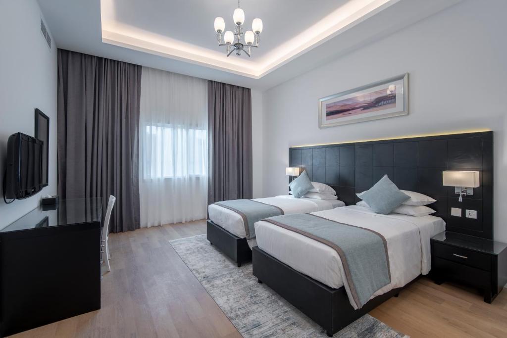 Кровать или кровати в номере Rose Garden Hotel Apartments - Al Barsha, Near Metro Station