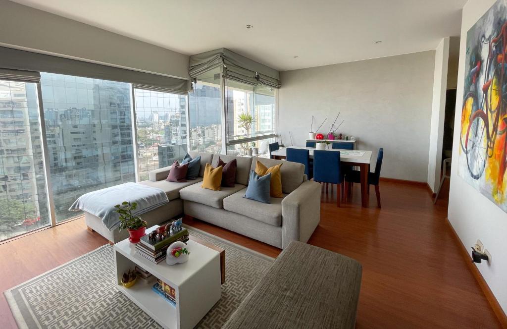 a living room with a couch and a table at Departamento Family in Lima