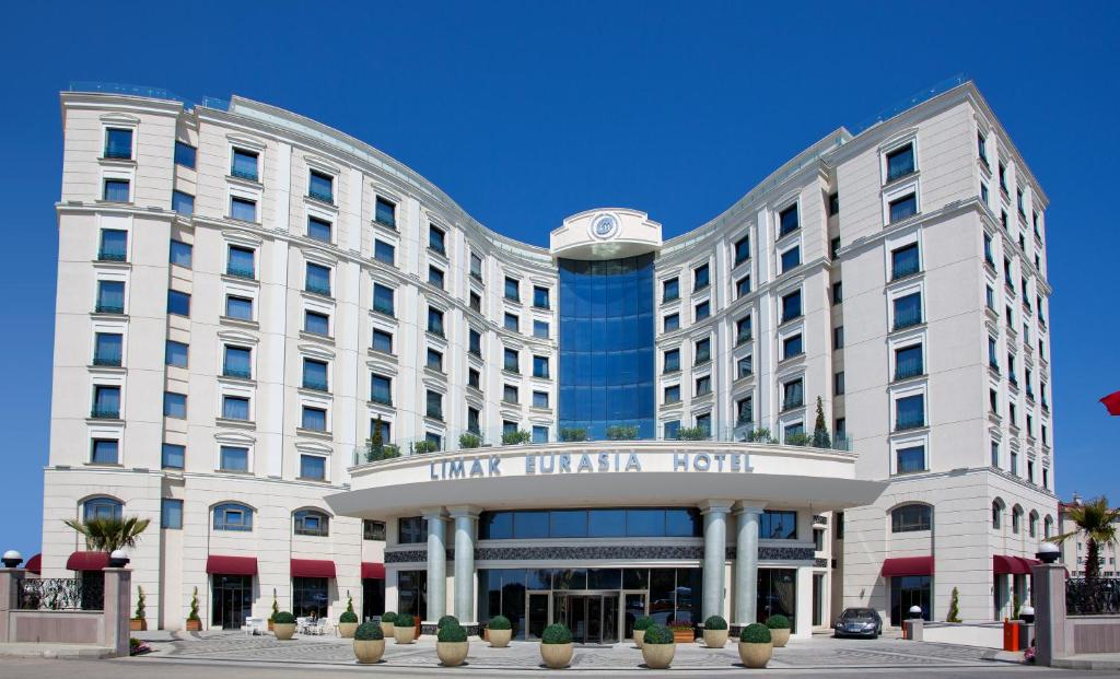a white building with a clock on top of it at Limak Eurasia Luxury Hotel in Istanbul