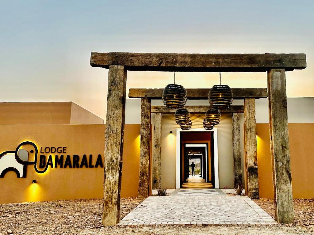 a hallway leading to a building with lights at Lodge Damaraland in Khorixas