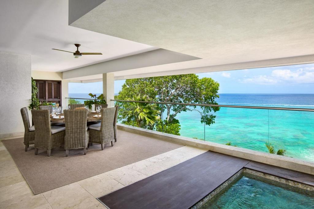 a dining room with a view of the ocean at Portico 3 by Blue Sky Luxury in Saint James