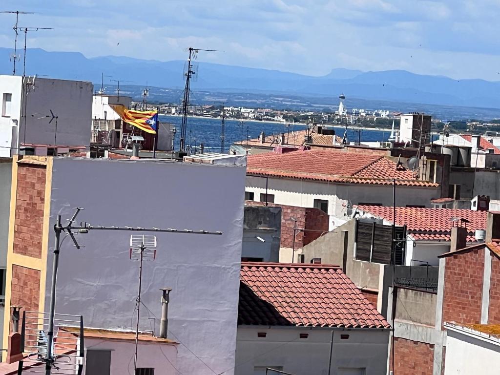 a collage of four pictures of roofs of buildings at L’Amirall in Roses