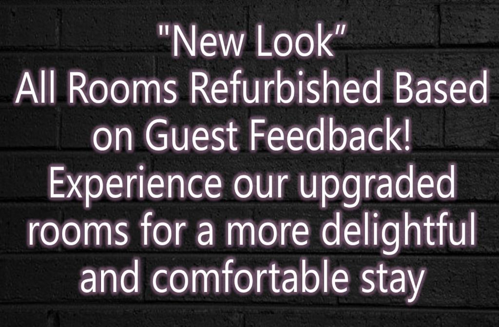 a sign on a wall that reads new look all rooms renovated based on guest feedback at The Furlong in Hawera