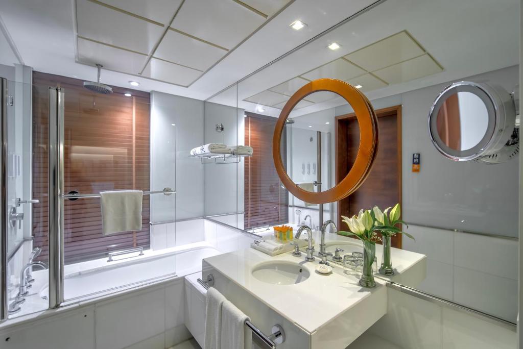 a bathroom with a sink and a mirror at Majestic Premier Hotel Burdubai in Dubai