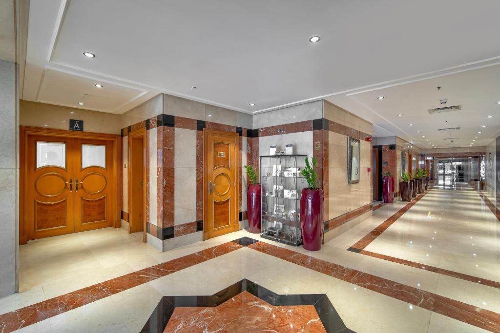 a large lobby with wooden doors and a hallway at Majestic Premier Hotel Burdubai in Dubai