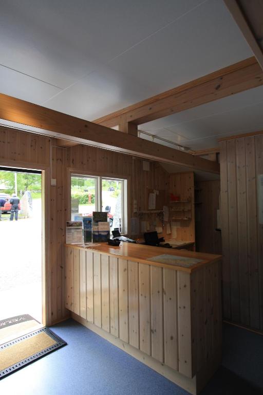 a kitchen with wooden walls and a counter in a room at Vinje Camping in Geiranger