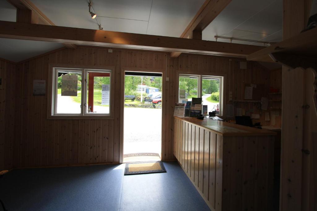 an empty room with a counter and a sliding glass door at Vinje Camping in Geiranger