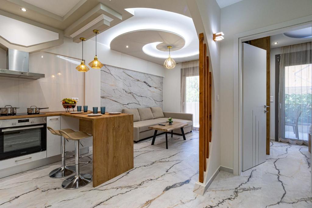 a kitchen and living room with marble flooring at Sergio Luxury Appartment in Nea Potidaea