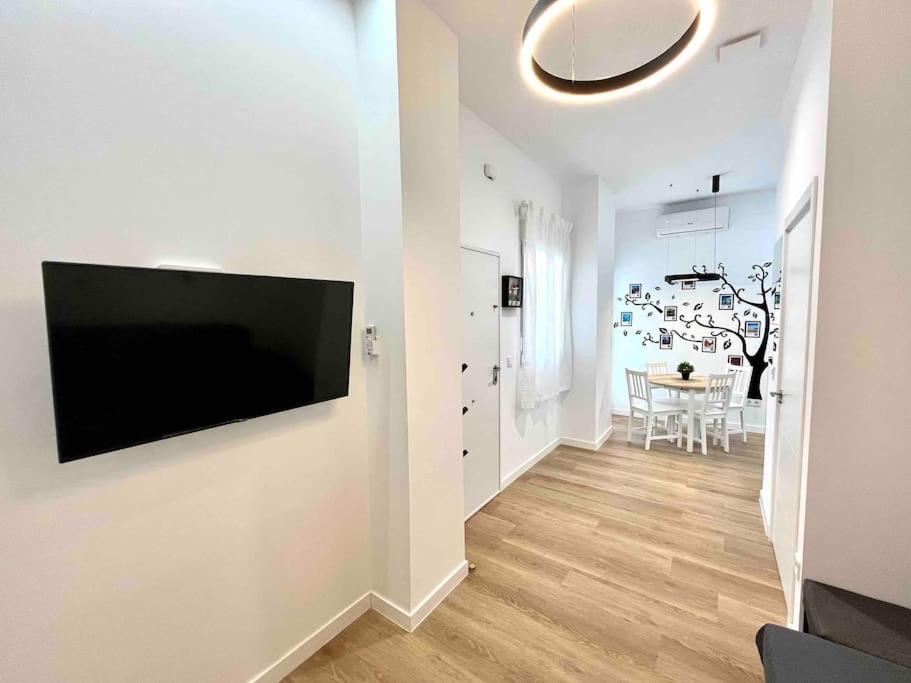 a living room with a flat screen tv on a wall at Acogedor apartamento 5 personas in Valencia