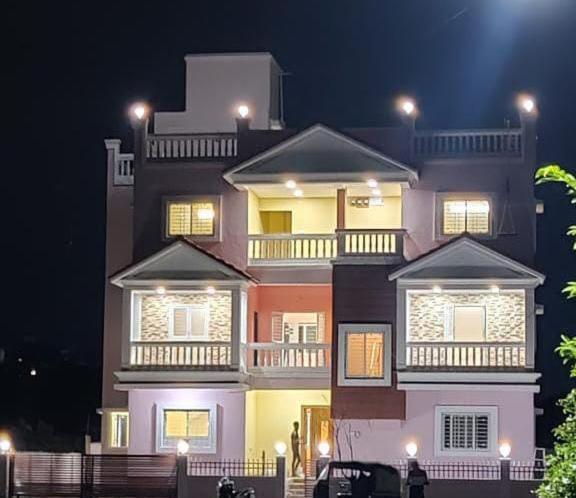 a large building with lights on top of it at night at Swapnashilp Bungalow in Hinjewadi