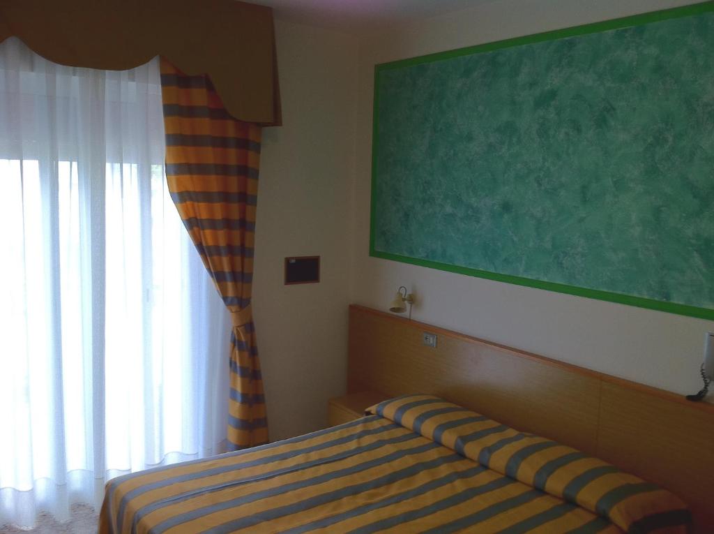 Uma cama ou camas num quarto em Hotel Altinate