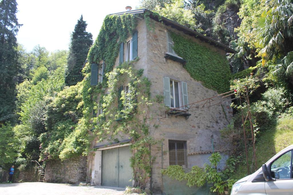a stone house with ivy on the side of it at VILLA SASSO Depandance in Cannobio