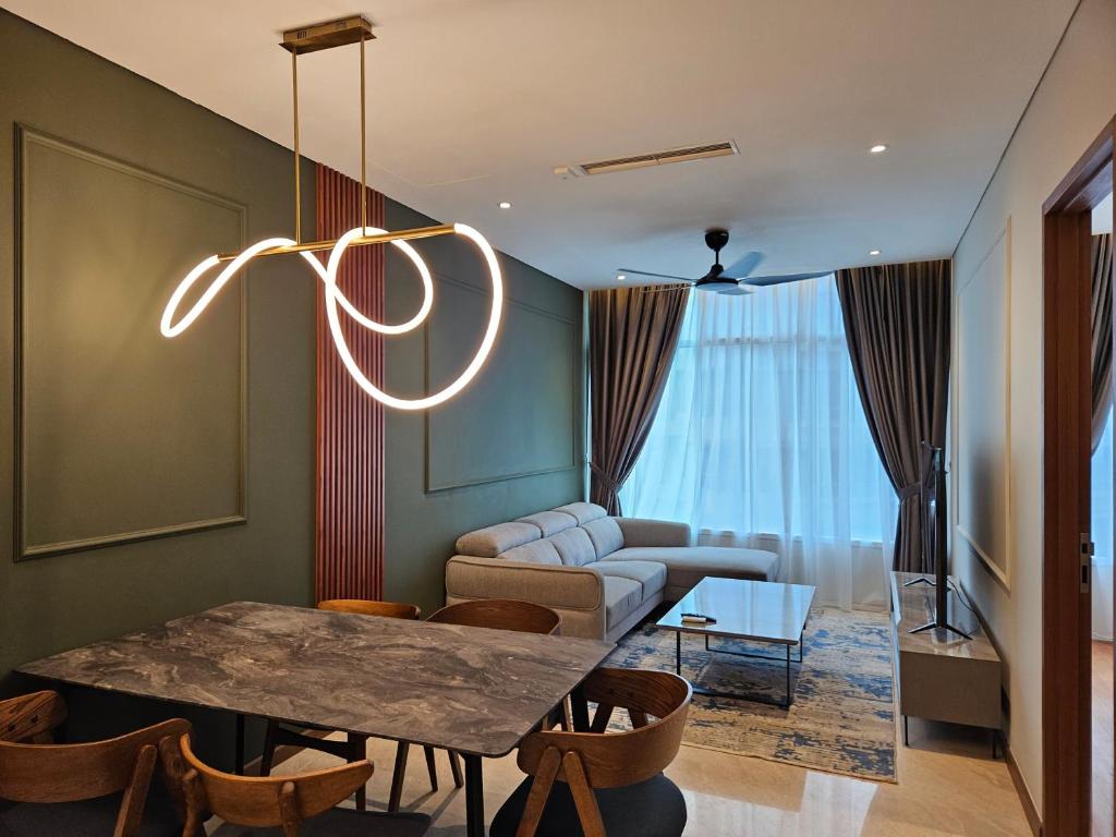 a living room with a table and a couch at Sky Suites KLCC by Asiapex in Kuala Lumpur