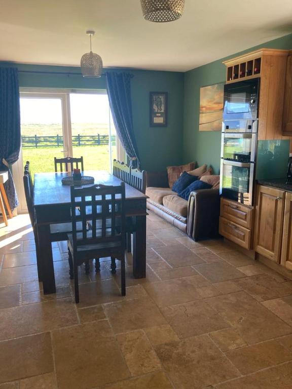a living room with a table and a couch at Shanadune in Tralee
