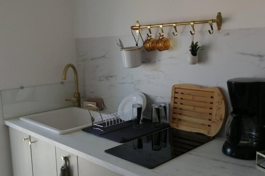 a kitchen counter with a sink and a sink at Appartement le quartier haut in Sète