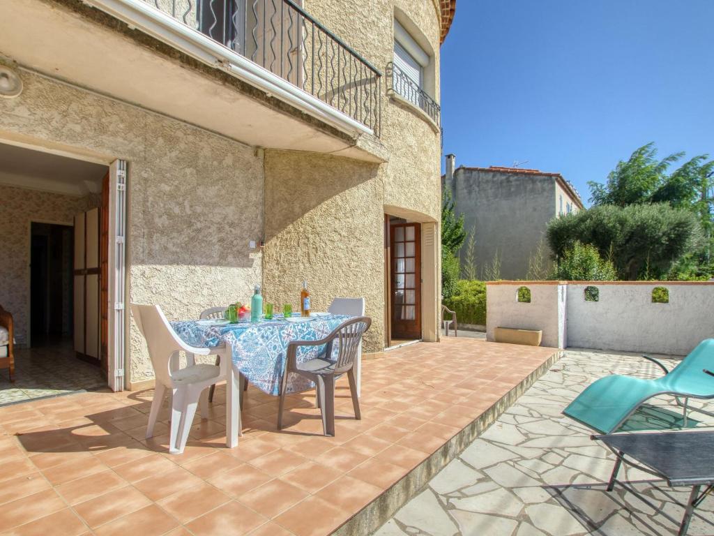 a patio with a table and chairs on a patio at Apartment La Caterina-1 by Interhome in Saint-Cyr-sur-Mer