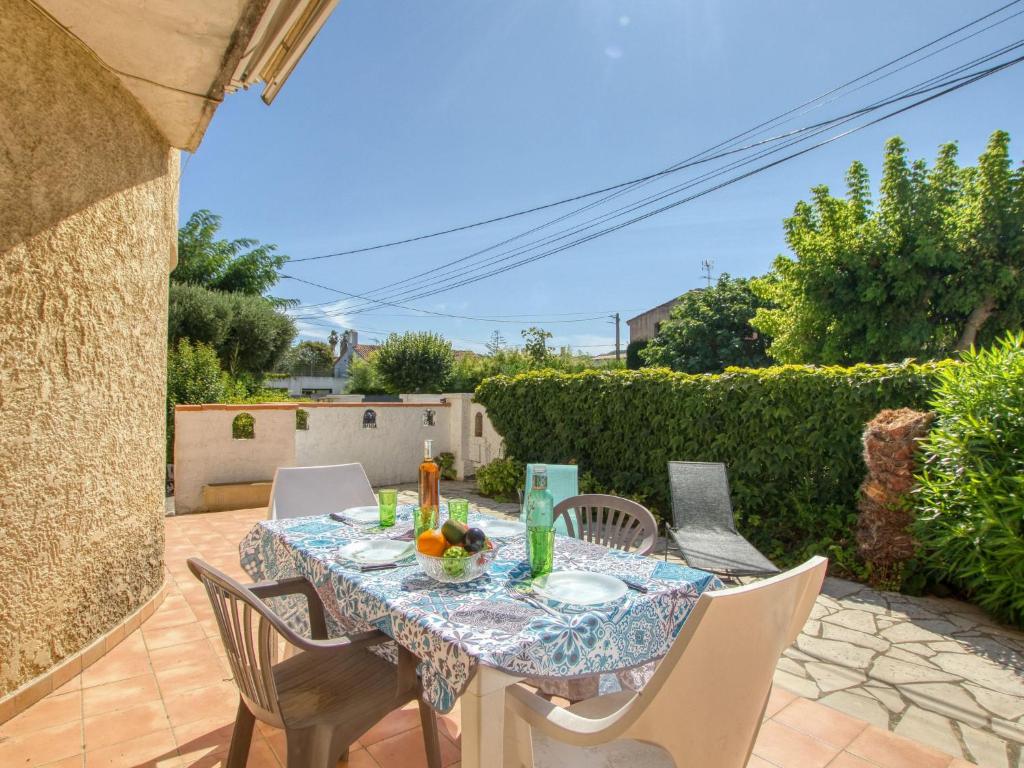 a patio with a table and chairs on a patio at Apartment La Caterina-1 by Interhome in Saint-Cyr-sur-Mer