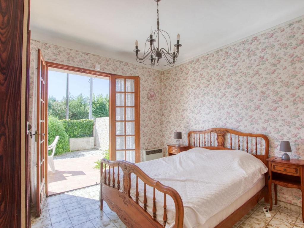 a bedroom with a bed and a sliding glass door at Apartment La Caterina-1 by Interhome in Saint-Cyr-sur-Mer