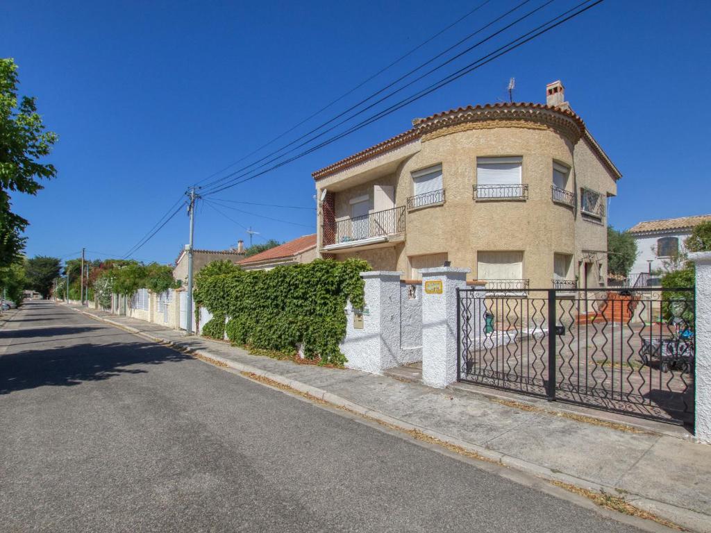 a building with a gate on the side of a street at Apartment La Caterina-1 by Interhome in Saint-Cyr-sur-Mer