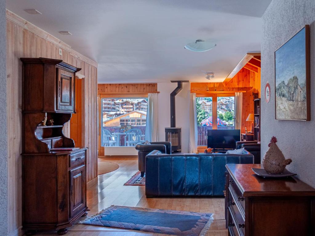 een woonkamer met een blauwe bank en een woonkamer bij Apartment Lake Placid A7 by Interhome in Nendaz