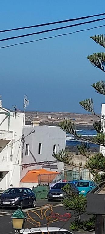 a city with cars parked in front of buildings at El Marinero, piso 2 y piso 3 in La Santa
