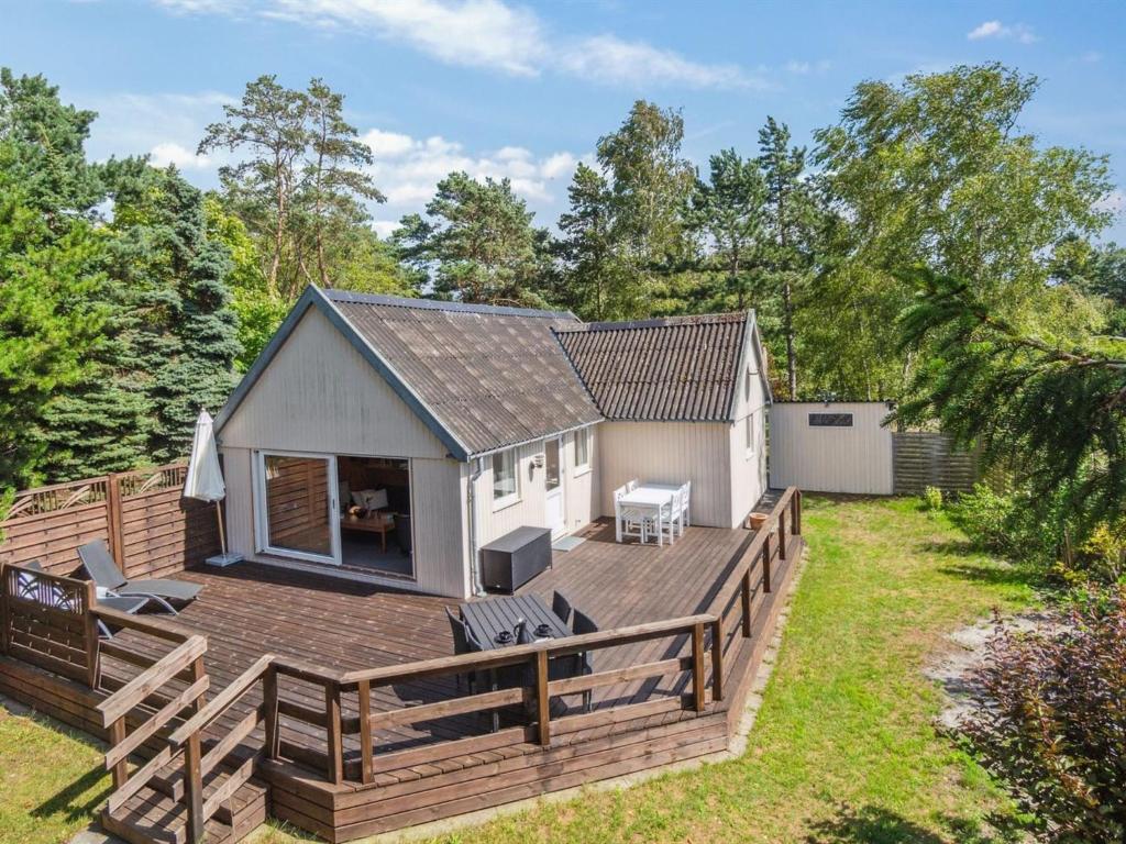 a house with a deck and a backyard at Holiday Home Hillmari - 650m from the sea in Bornholm by Interhome in Vester Sømarken