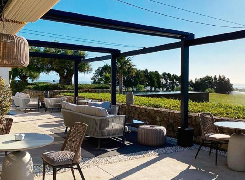 a patio with chairs and tables and aivatedivatedivatedivatedivatedivatedivatedivated at La Alcaidesa Valerie Bruno in San Roque