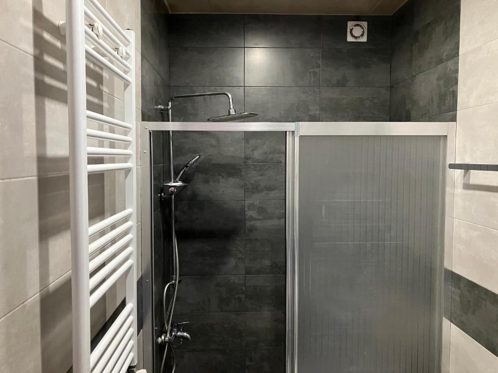 a shower with a glass door in a bathroom at Villa Old Batumi in Batumi