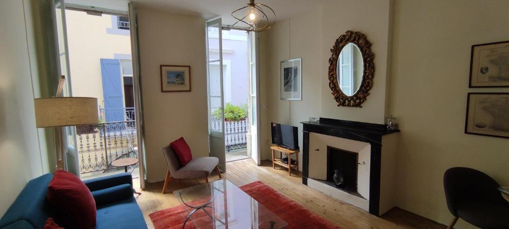 a living room with a fireplace and a mirror at The Apartments, Rue Barbès in Carcassonne