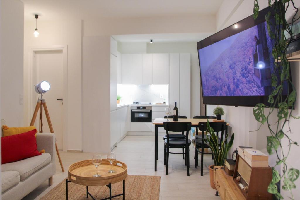 a living room with a tv on the wall at Phos Luxury Apartment in Lefkada Town