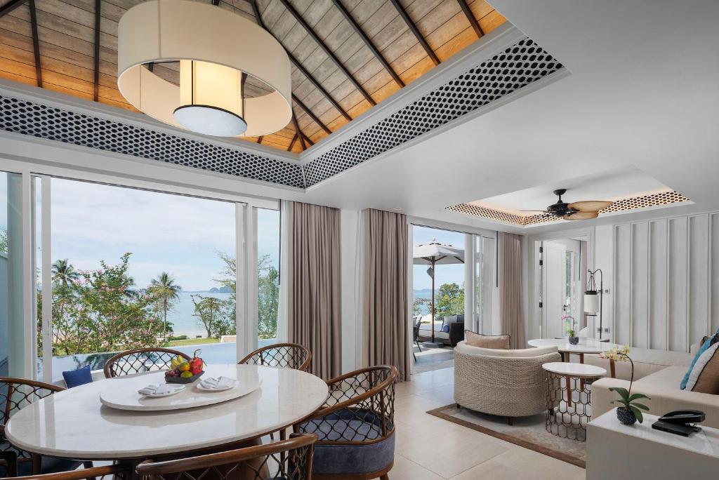 a living room with a table and chairs at Banyan Tree Krabi in Tab Kaek Beach
