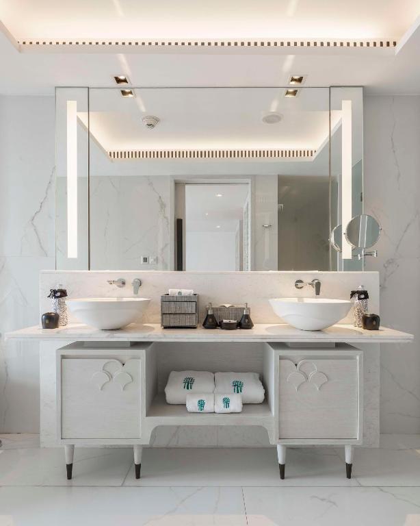 a bathroom with two sinks and a large mirror at Banyan Tree Krabi in Tab Kaek Beach