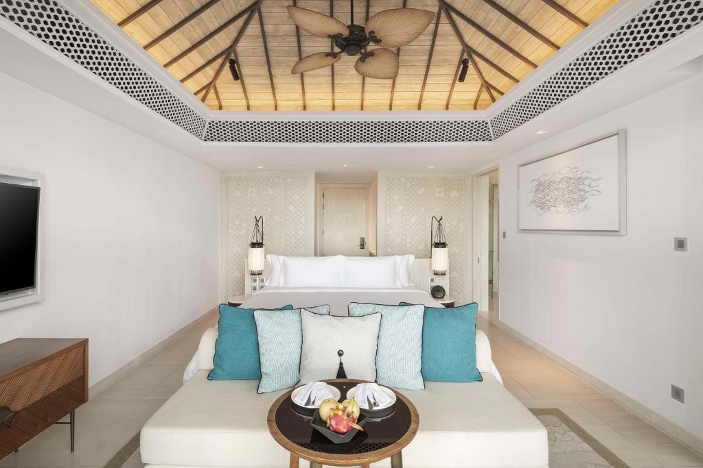 a living room with a couch and a bed at Banyan Tree Krabi in Tab Kaek Beach