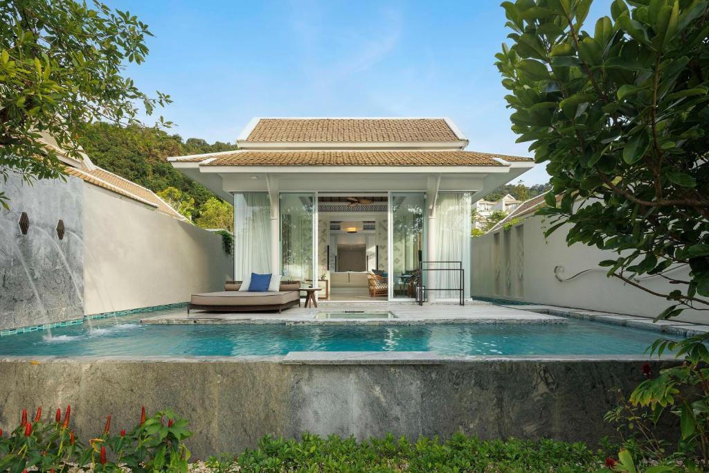 a villa with a swimming pool and a house at Banyan Tree Krabi in Tab Kaek Beach