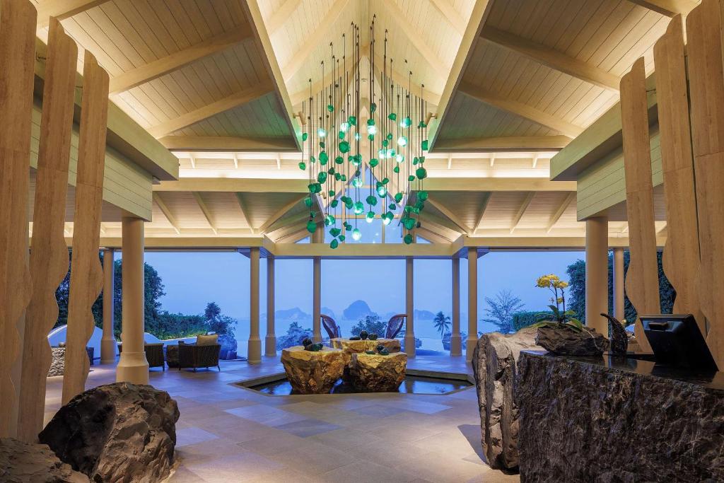 a room with a large ceiling with a chandelier at Banyan Tree Krabi in Tab Kaek Beach