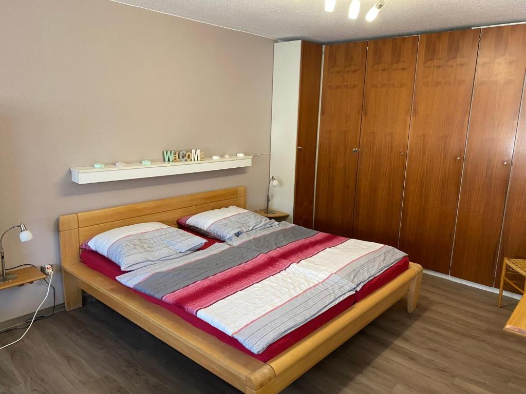 a bedroom with a bed and a wooden cabinet at Haus enere Au in Todtmoos