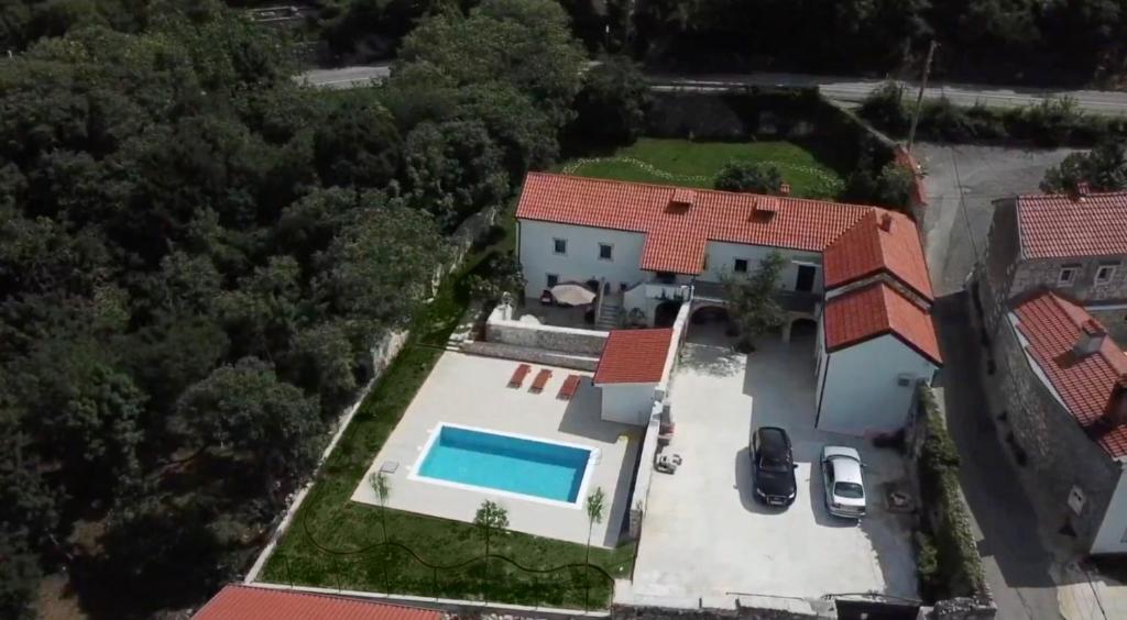 an aerial view of a house with a swimming pool at Mansion Art House 1800 in Tribalj