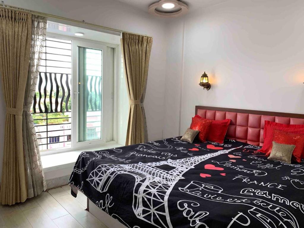 a bedroom with a bed with a red headboard and a window at Luxury 3BHK Aprtmnt City View Balcony HSpeed Wifi Free Parking in Kolkata