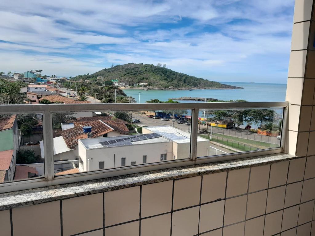 a balcony with a view of the ocean at Apartamento com vista para o mar em Setiba Guarapari in Guarapari