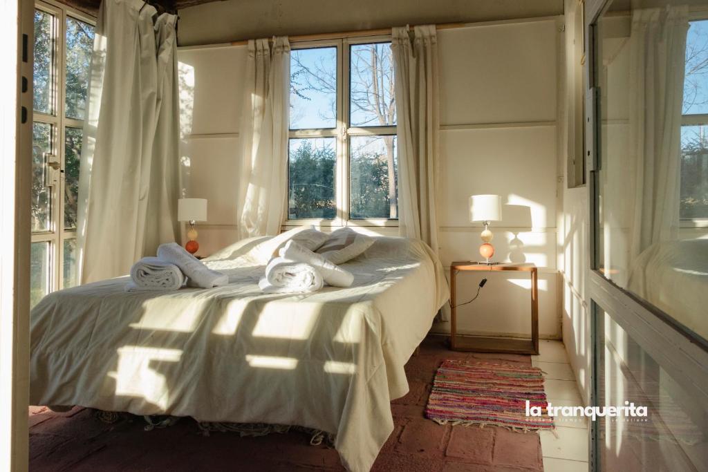 a bedroom with a bed with towels on it at Finca La Tranquerita in San Rafael